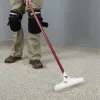 Scrubbing carpt cleaning treatment into the carpet.